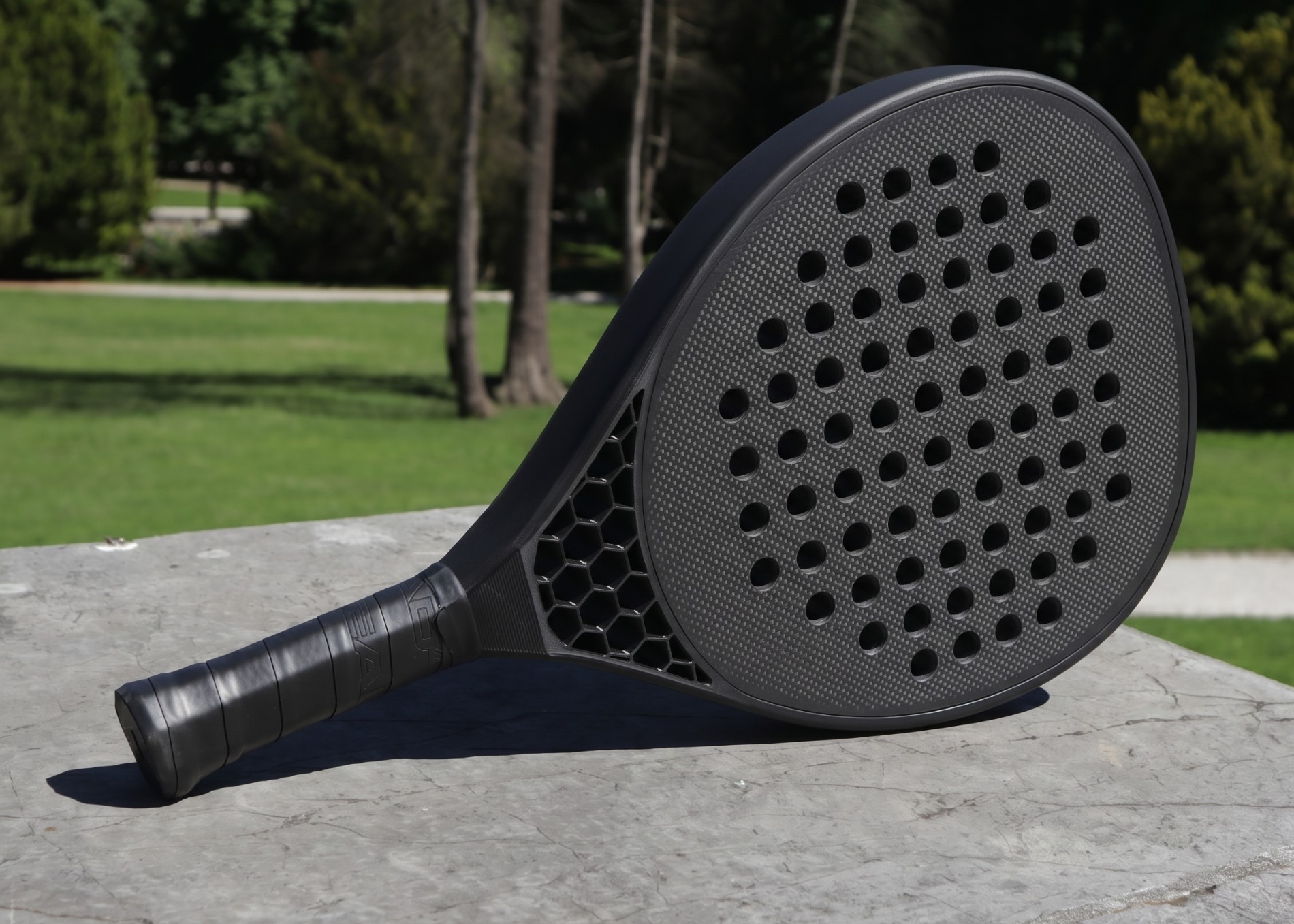 T0 Hex — three-quarter view resting on stone